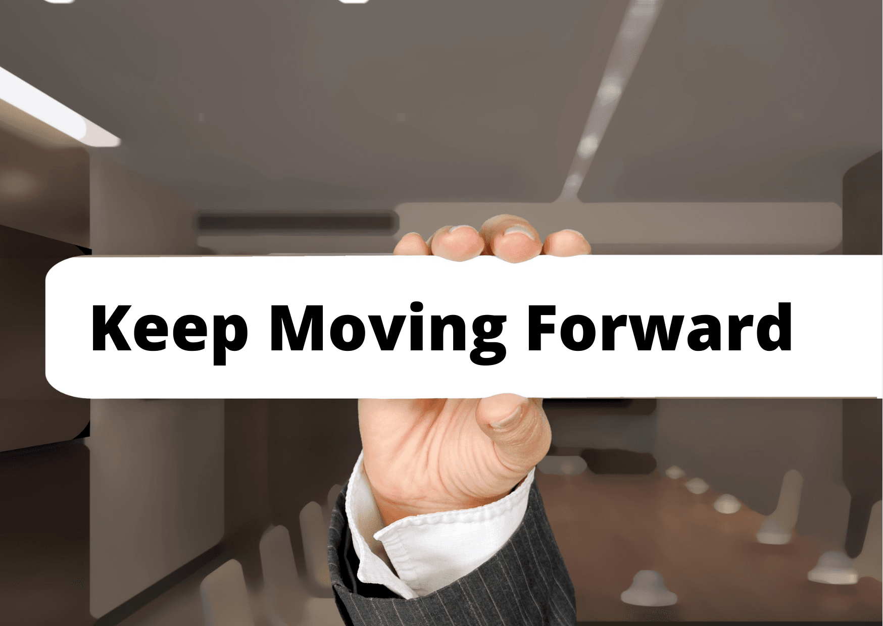 Professional holding a keep moving forward sign during a job search