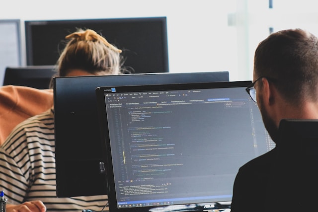 Two Cloud engineers working behind their screens
