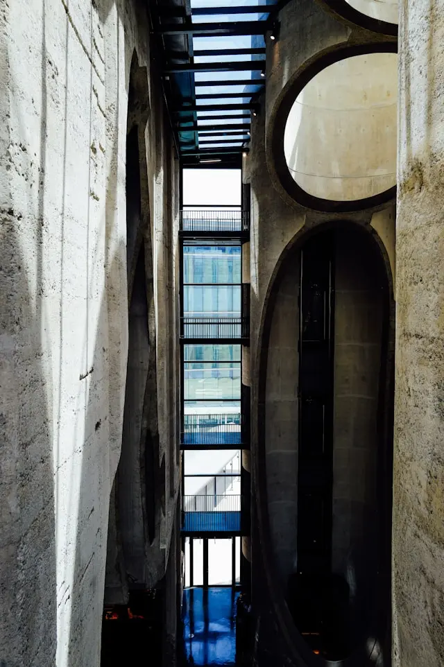 Modern concrete interior with glass walkways and curved architectural openings