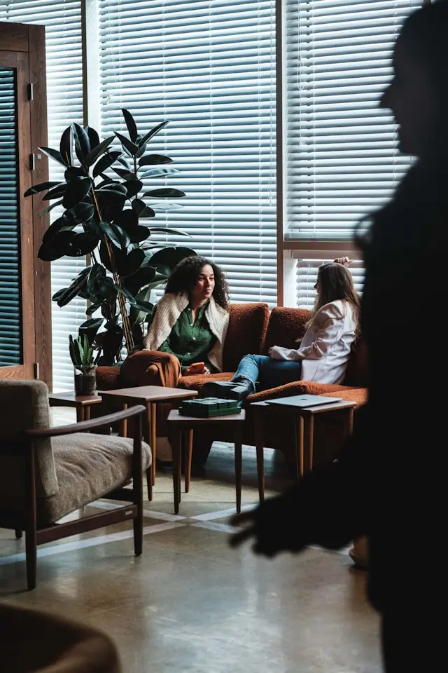 Project delivery professionals discussing work together in a modern office