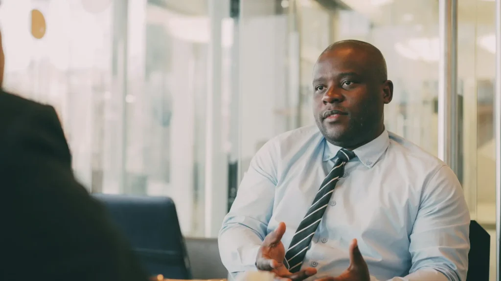 Business Analyst professional in discussion with a colleague