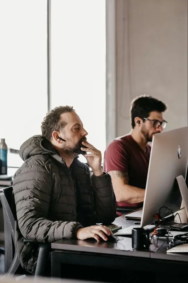Cybersecurity analyst and engineer working at their desks