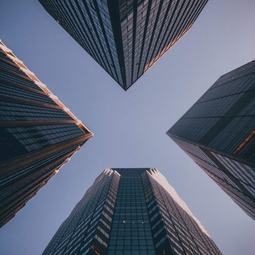 Looking up between modern office buildings and skyscrapers recruitment consultancy south africa
